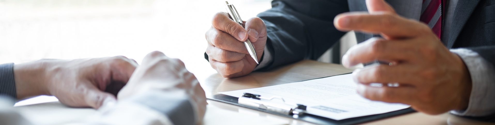 A counsellor in financial recovery chats with a man while looking at a document