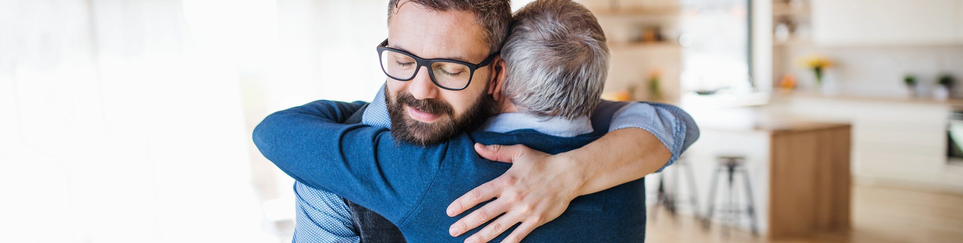 Two men share a friendly hug